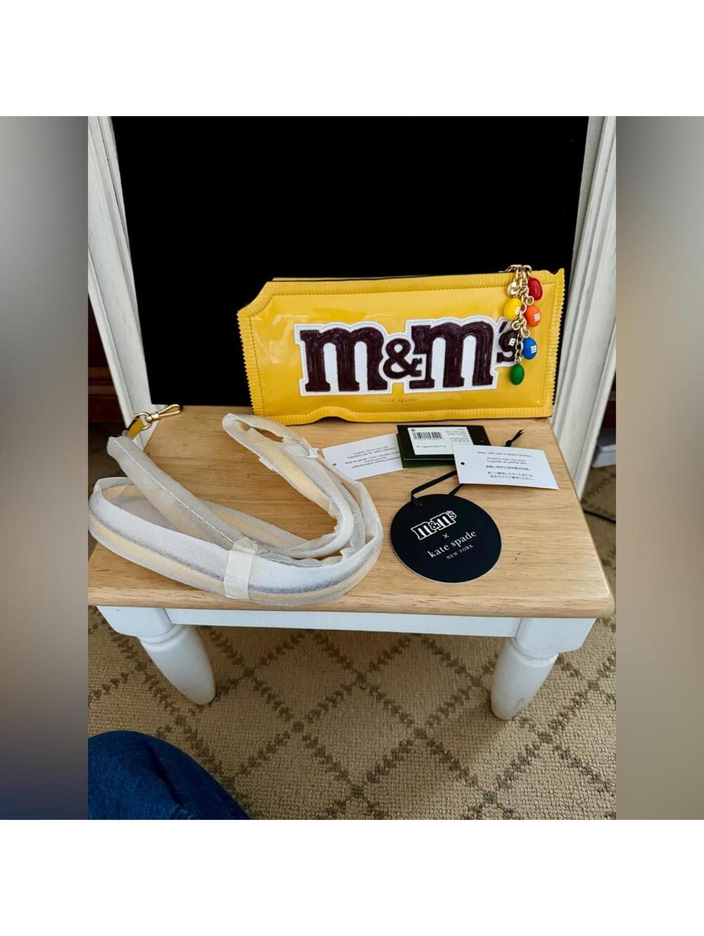 kate spade yellow M&M's patent wristlet with colorful charm
